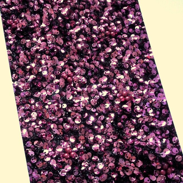 Curved sequins in Izmir Purple on black raffia tulle | View: Curved sequins embroidered with pearls in Izmir Purple on black raffia tulle