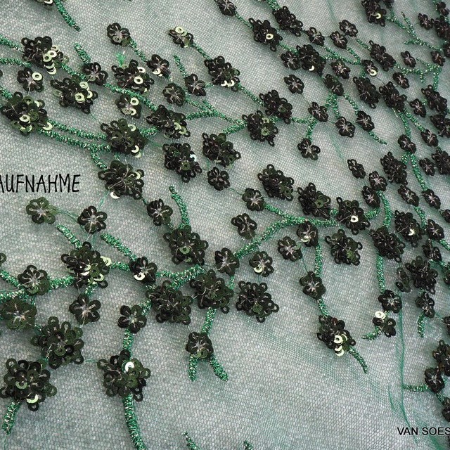 Fir green branches of mini sequins on green colored tulle.