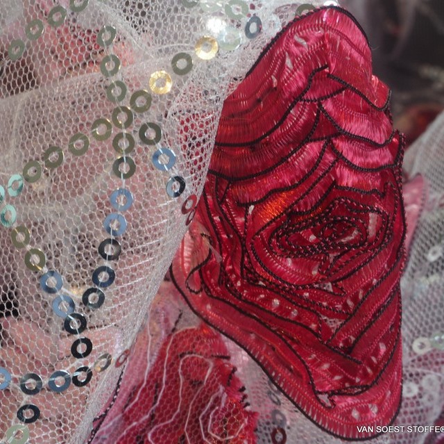 abstract red 3D flowers on a silver sequin net on white tulle | View: abstract red 3D flowers on a silver sequin net on white tulle