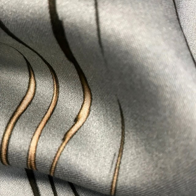 super nice, soft 100% viscose print in silver with earth tone stripes reminiscent of twigs