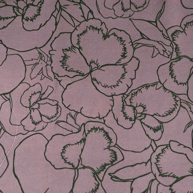Delicate floral print in green lilac on lightweight rayon mix satin